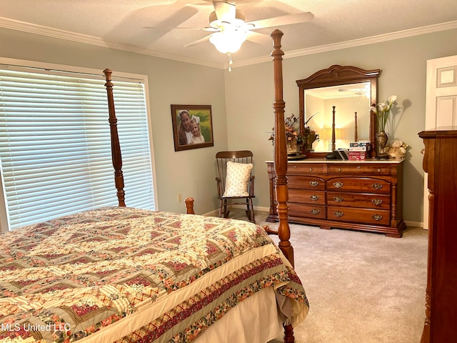 bedroom featuring ornamental molding, a textured ceiling, light colored carpet, and ceiling fan