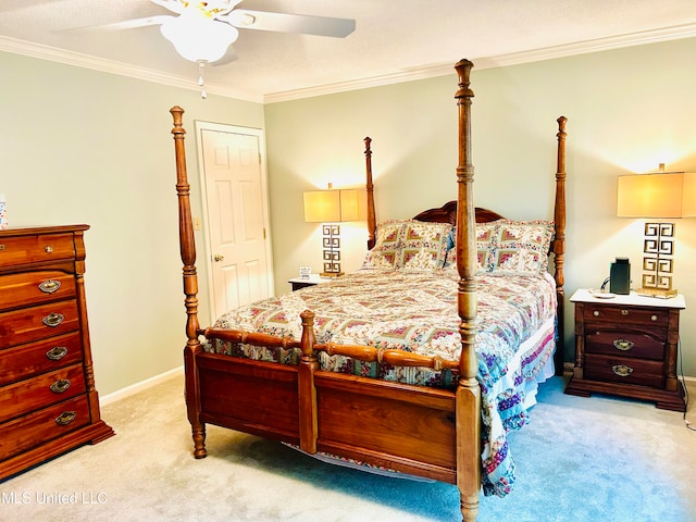 carpeted bedroom featuring ceiling fan and ornamental molding