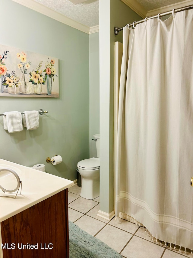 bathroom featuring vanity, toilet, tile patterned floors, and a textured ceiling