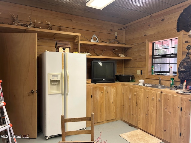 kitchen with wooden walls and white refrigerator with ice dispenser