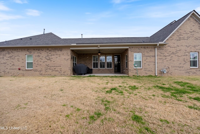 7327 Sunstone Dr, Olive Branch, MS 38654 - back of house with a lawn, brick siding, a ceiling fan, and a patio