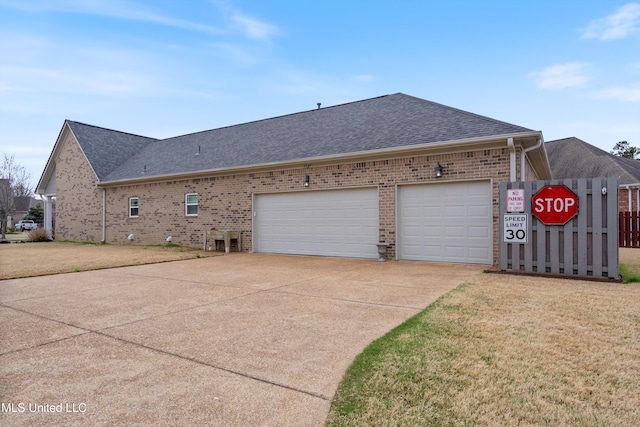 7327 Sunstone Dr, Olive Branch, MS 38654 - view of side of property featuring brick siding, driveway, a shingled roof, and a garage
