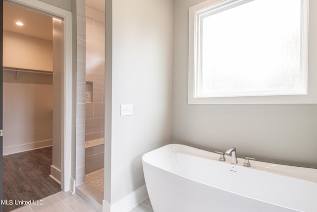 bathroom featuring hardwood / wood-style flooring and independent shower and bath