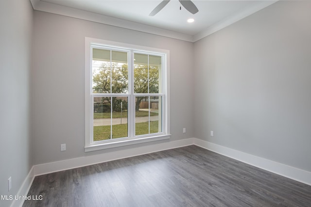 spare room featuring dark wood-type flooring, ceiling fan, and crown molding