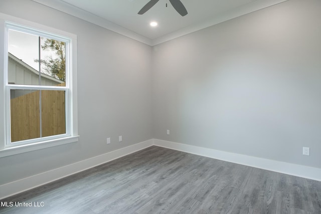 spare room featuring ornamental molding, hardwood / wood-style flooring, and ceiling fan