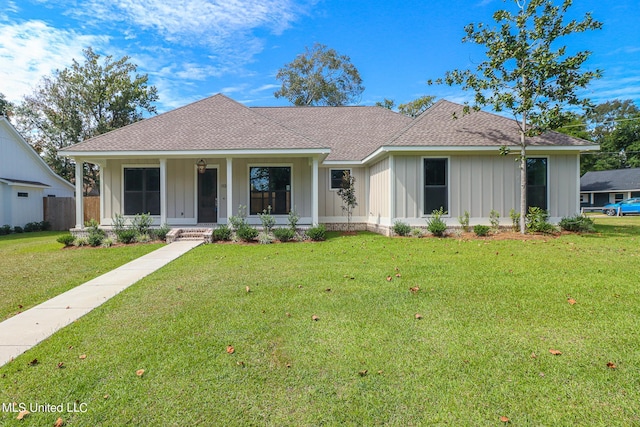 view of front of home with a front yard and a porch