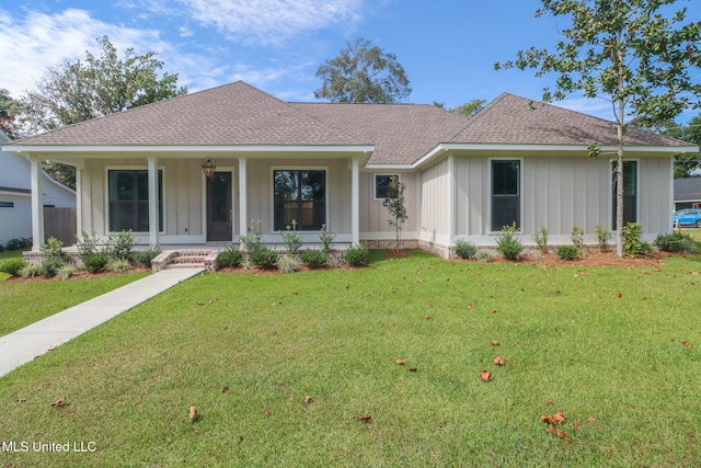 view of front of property with covered porch and a front lawn