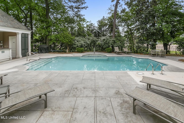 view of swimming pool with a patio area