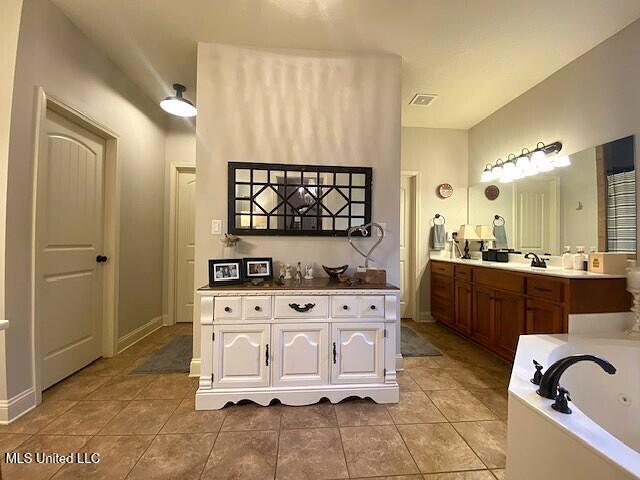 771 Robertson Way, Hernando, MS 38632 - bathroom featuring a whirlpool tub, vanity, and tile patterned flooring