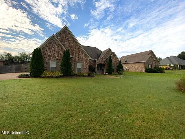 771 Robertson Way, Hernando, MS 38632 - view of front of property with brick siding and a front lawn