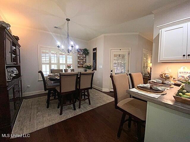 771 Robertson Way, Hernando, MS 38632 - dining room with dark wood finished floors, a chandelier, and ornamental molding