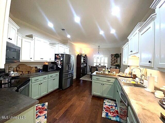 771 Robertson Way, Hernando, MS 38632 - kitchen with black appliances, a peninsula, dark wood-style floors, white cabinetry, and decorative light fixtures