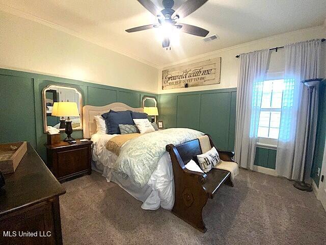 771 Robertson Way, Hernando, MS 38632 - carpeted bedroom featuring a decorative wall, crown molding, a wainscoted wall, and a ceiling fan