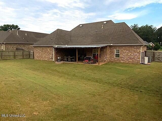 771 Robertson Way, Hernando, MS 38632 - rear view of house featuring a patio area, a fenced backyard, and brick siding