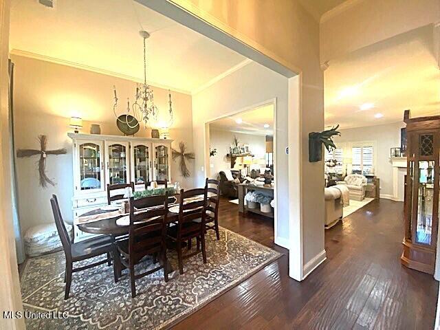 771 Robertson Way, Hernando, MS 38632 - dining area featuring hardwood / wood-style floors, crown molding, and a chandelier