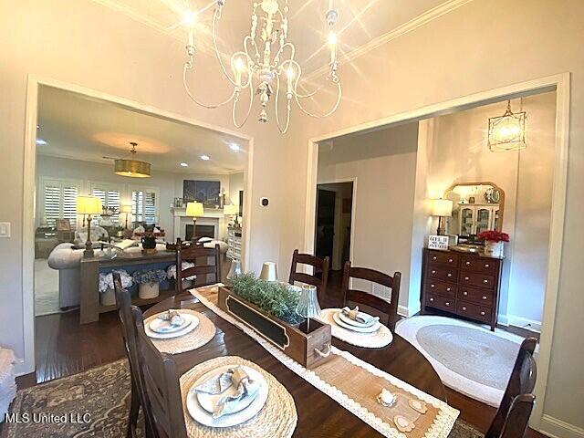 771 Robertson Way, Hernando, MS 38632 - dining room featuring a chandelier, wood finished floors, and crown molding
