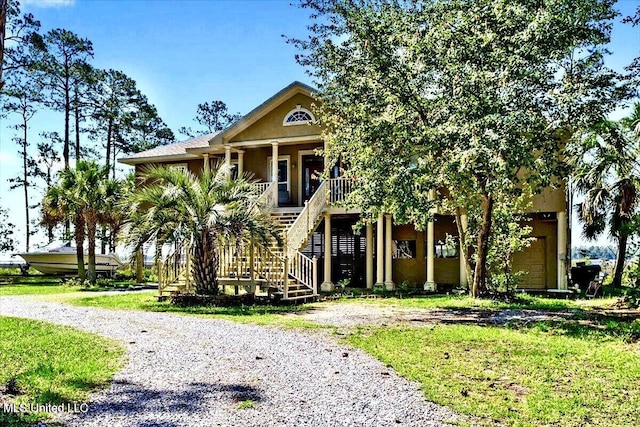 6301 Mary Mahoney Dr, Ocean Springs, MS 39564 - beach home featuring covered porch, stairs, and stucco siding