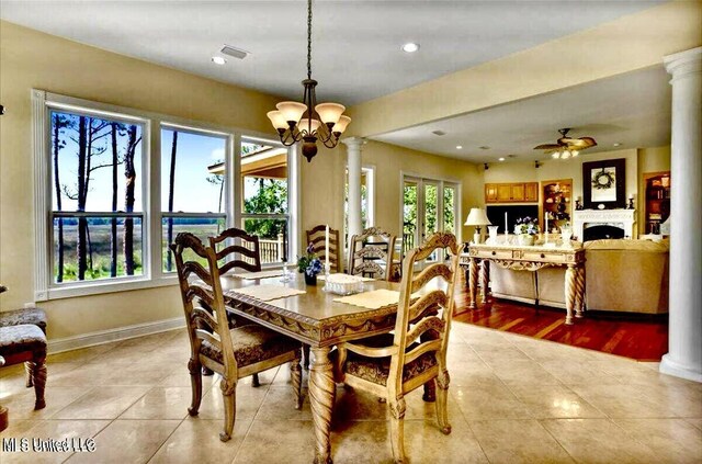 6301 Mary Mahoney Dr, Ocean Springs, MS 39564 - dining room with ornate columns, a chandelier, light tile patterned flooring, ceiling fan, and recessed lighting