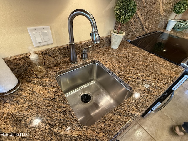 6301 Mary Mahoney Dr, Ocean Springs, MS 39564 - kitchen view of a sink, stovetop, and dark stone countertops