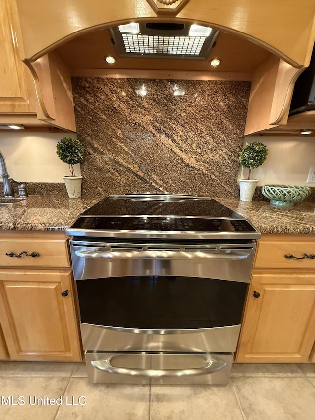 6301 Mary Mahoney Dr, Ocean Springs, MS 39564 - kitchen featuring electric stove, light tile patterned floors, arched walkways, and light brown cabinets