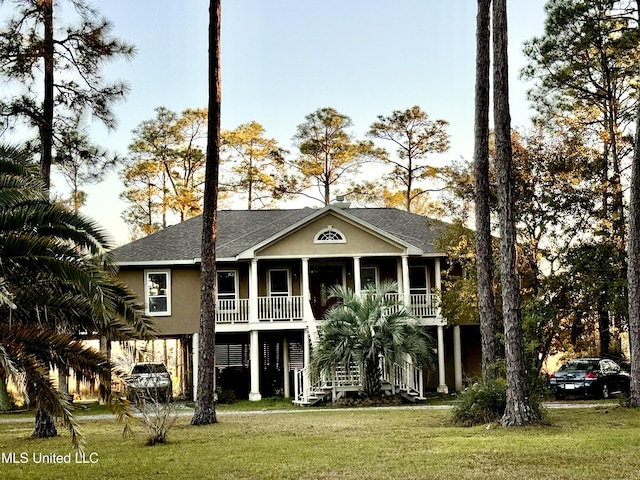 6301 Mary Mahoney Dr, Ocean Springs, MS 39564 - view of front facade featuring covered porch, a front lawn, stucco siding, and stairway