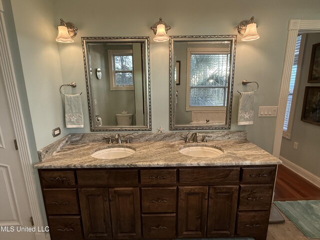 6301 Mary Mahoney Dr, Ocean Springs, MS 39564 - full bathroom featuring toilet, double vanity, and baseboards