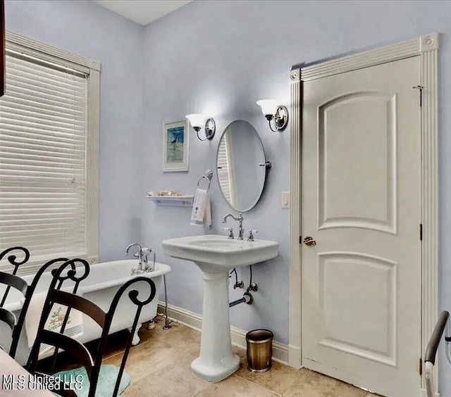 6301 Mary Mahoney Dr, Ocean Springs, MS 39564 - full bathroom with a freestanding tub, tile patterned floors, and baseboards