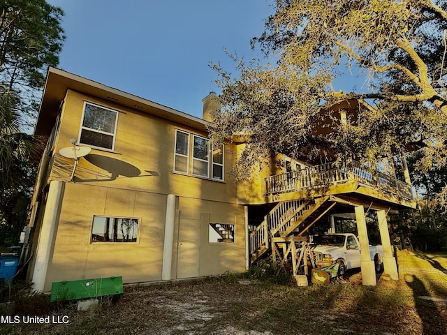6301 Mary Mahoney Dr, Ocean Springs, MS 39564 - rear view of house with stairs, a chimney, and a deck