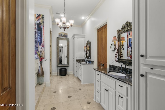 bathroom with tile patterned floors, vanity, an inviting chandelier, and crown molding