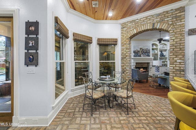 interior space featuring ceiling fan, wood ceiling, hardwood / wood-style flooring, and ornamental molding