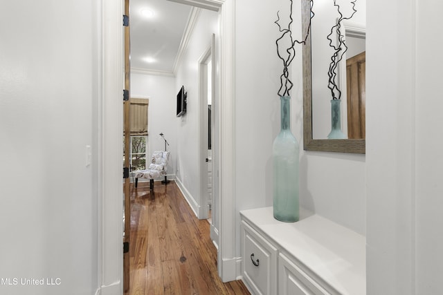 corridor with crown molding and hardwood / wood-style flooring