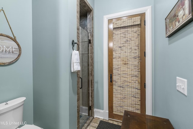 bathroom featuring walk in shower and toilet