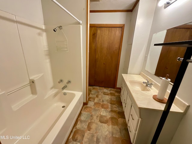 bathroom with  shower combination, vanity, and crown molding