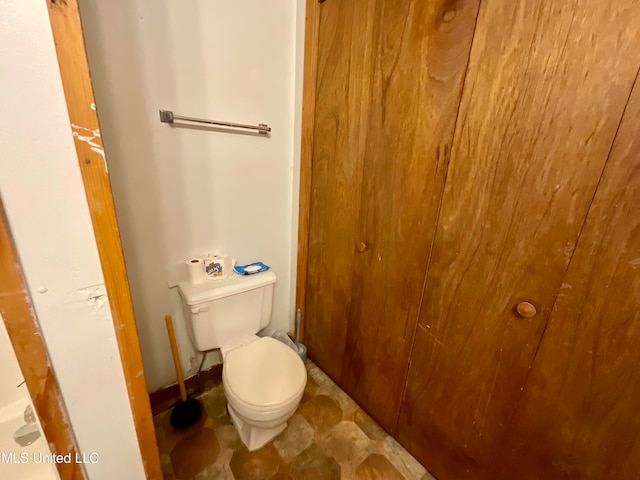 bathroom with toilet and tile patterned flooring