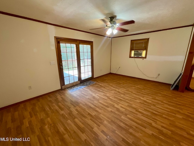 unfurnished room with cooling unit, ornamental molding, hardwood / wood-style floors, a textured ceiling, and ceiling fan