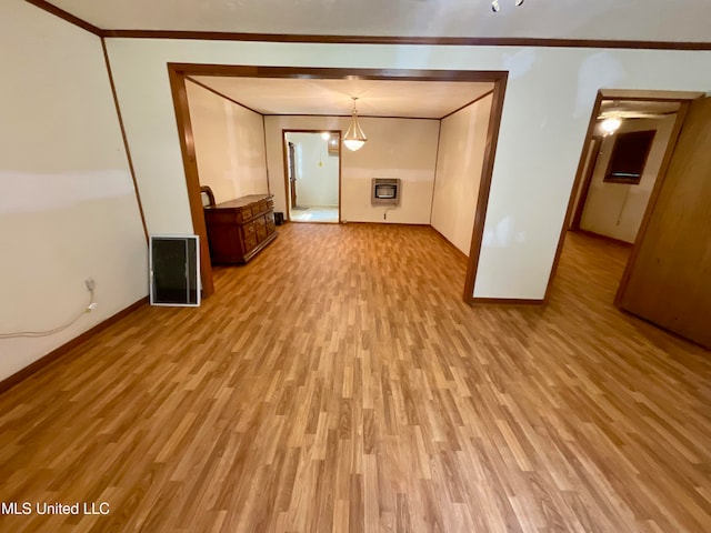 interior space featuring crown molding, heating unit, and light wood-type flooring