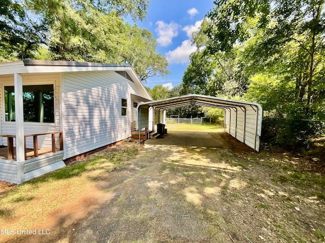 view of side of home with a carport