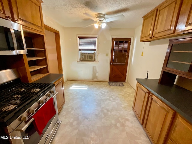 kitchen featuring appliances with stainless steel finishes, cooling unit, a textured ceiling, and ceiling fan