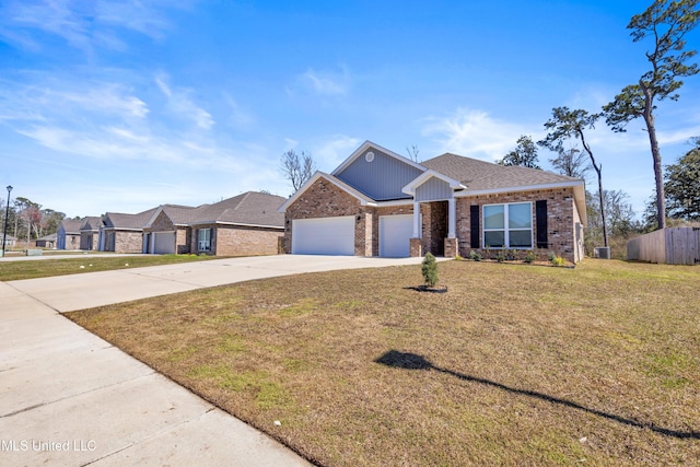 view of front facade with an attached garage, brick siding, fence, concrete driveway, and a front yard