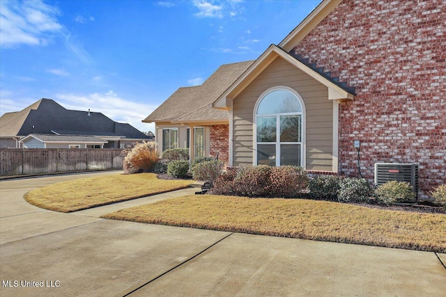 exterior space featuring a yard and central AC unit