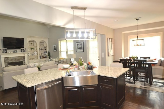 8146 Wisteria Dr, Olive Branch, MS 38654 - kitchen featuring stainless steel dishwasher, open floor plan, dark wood-style flooring, decorative light fixtures, and lofted ceiling