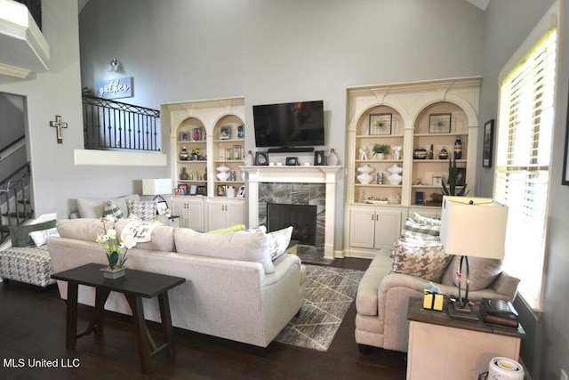 8146 Wisteria Dr, Olive Branch, MS 38654 - living area featuring a fireplace, high vaulted ceiling, dark wood-style flooring, and built in features