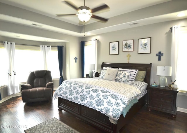 8146 Wisteria Dr, Olive Branch, MS 38654 - bedroom with dark wood-type flooring, a raised ceiling, and ceiling fan