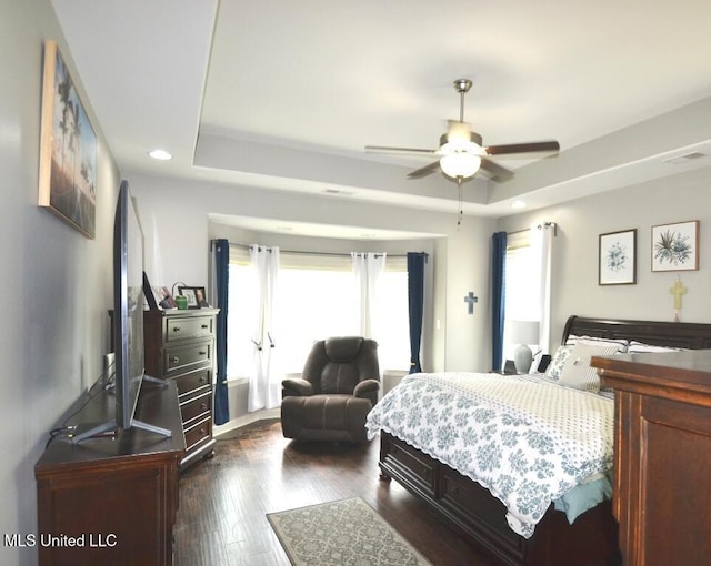 8146 Wisteria Dr, Olive Branch, MS 38654 - bedroom featuring a tray ceiling, dark wood-style floors, recessed lighting, and a ceiling fan