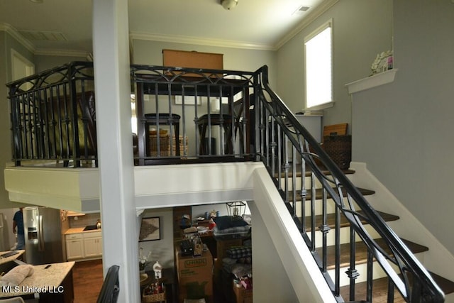 8146 Wisteria Dr, Olive Branch, MS 38654 - stairs featuring ornamental molding and wood finished floors