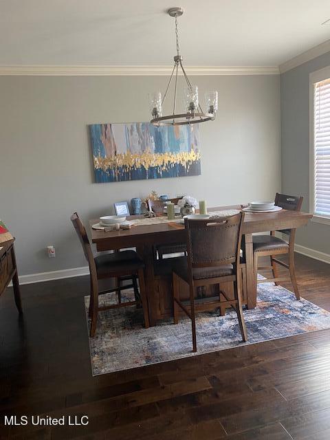 8146 Wisteria Dr, Olive Branch, MS 38654 - dining area featuring a chandelier, crown molding, and wood finished floors