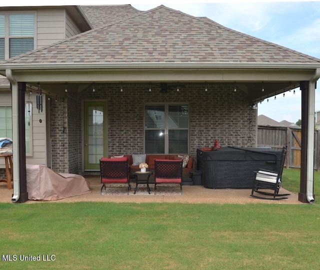 8146 Wisteria Dr, Olive Branch, MS 38654 - back of property featuring outdoor lounge area, roof with shingles, brick siding, and a patio area