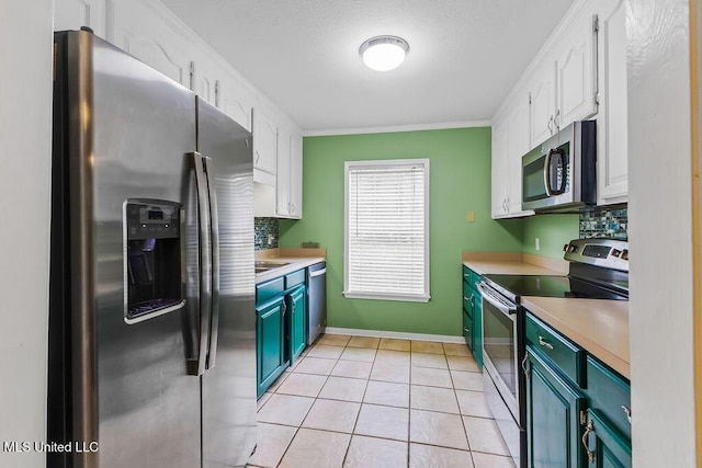 kitchen featuring light countertops, white cabinetry, stainless steel appliances, and light tile patterned floors