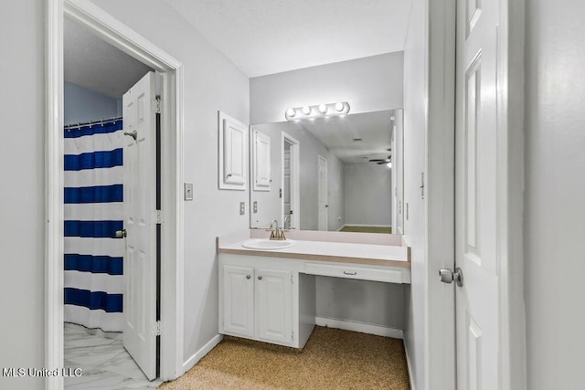 full bath with a ceiling fan, baseboards, vanity, and a shower with shower curtain