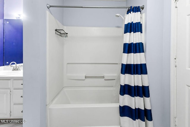 full bath featuring vanity and shower / bath combo
